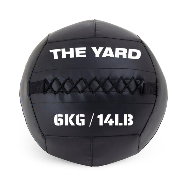 The Yard - Wall Ball 6kg by SMAI is a black gym ball with visible stitching, featuring "THE YARD" at the top and "6KG / 14LB" in bold white text on the front.