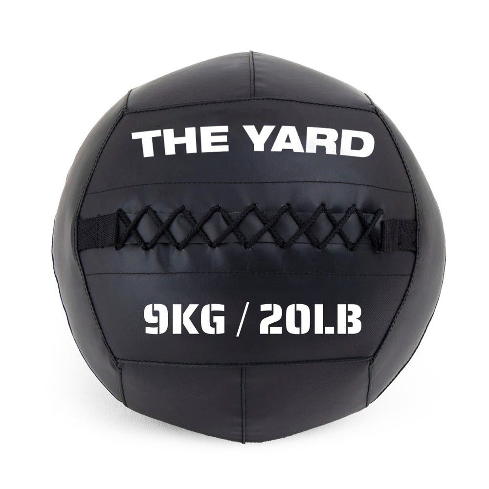 The SMAI The Yard - Wall Ball 9kg is a black wall ball made from recycled rubber, with "THE YARD" on top and "9KG / 20LB" below, visible stitching across the middle—ideal for your gym fitness routine.