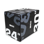 The Plyometric Box - WOD Pro by SMAI is a competition-grade piece of equipment featuring a black and gray design with bold white and gray numbers. The numbers "24", "30", and "20" indicate different height options for jump exercises, offering versatility through its sturdy EVA foam construction, with the brand name "SMAI" printed on its sides.