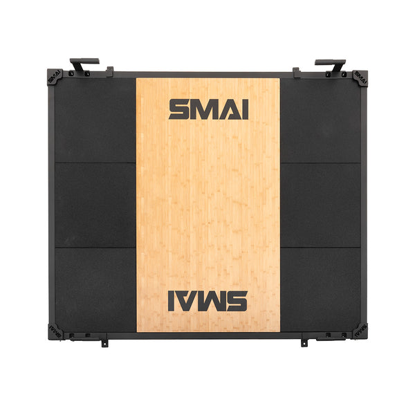 The SMAI Weight Lifting Platform - Black features a rectangular design with a wooden center panel displaying the "SMAI" logo at both ends and black rubber sides. Seen from above, it's perfect for barbell weight training sessions.