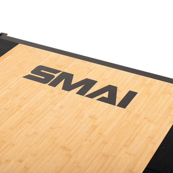 The SMAI Weight Lifting Platform - Black features a light bamboo grain surface with black edges and "SMAI" branding, ideal for barbell weight training.