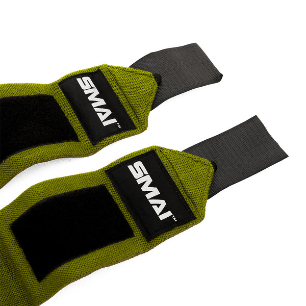 A close-up of two green and black SMAI Wrist Support Wraps - Weightlifting, featuring Velcro fastenings, displayed on a white background.