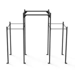 The "Rig - 4 Squat Cells with Utility Bridge - X-Frame" by No Sync To Channel Engine is a spacious, black, metal workout rig featuring multiple bars and adjustable height. Built with a sturdy frame reminiscent of commercial equipment, its modular design makes it ideal for fitness and strength training exercises. It stands out prominently against a plain white background.