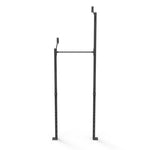 The Wall Mounted Rig - 1 Squat Cell with Bridge - X-Frame, by No Sync To Channel Engine, is crafted from sturdy black metal and features a robust steel tubing design. It includes two vertical supports and a horizontal bar at the top. Its modular design offers multiple adjustment holes for versatile fitness applications. Additionally, it comes with a structural warranty to ensure lasting durability, all set against a white background.