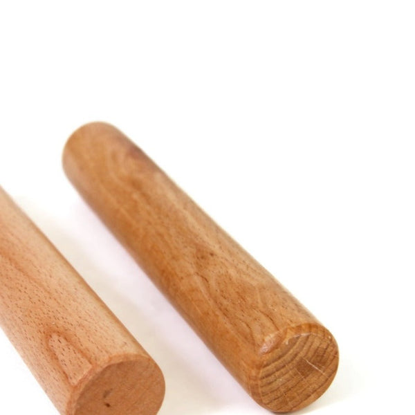 The SMAI Wooden Pegs (Pair), designed to resemble cylindrical massage rollers, are positioned side by side on a white surface.