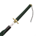 A close-up of the SMAI Shackled Emerald Anime Display Katana being partly drawn from its black scabbard, revealing a green-wrapped handle with black diamond patterns, a gold-toned guard, and a chain on the pommel.