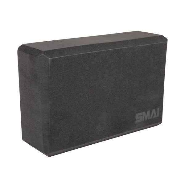 The SMAI Yoga Block - Black is a rectangular high-density foam block with beveled edges and the "SMAI" logo in white, perfect for pilates.
