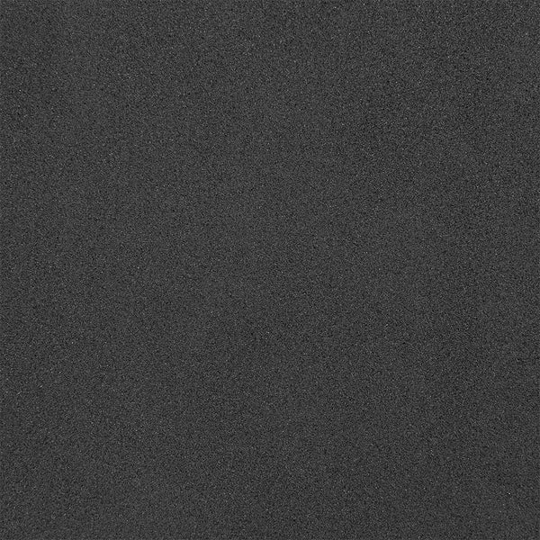 A close-up of the SMAI Yoga Block - Black reveals its smooth, dark gray surface with a fine, sandpaper-like texture, evoking the look of stone or matte industrial materials.