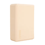 The SMAI Yoga Block - Camel is a beige rectangular foam block with beveled edges and "SMAI" embossed on one side—an essential accessory for added support in yoga practice.