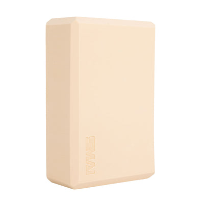 The SMAI Yoga Block - Camel is a beige rectangular foam block with beveled edges and "SMAI" embossed on one side—an essential accessory for added support in yoga practice.