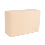 The SMAI Yoga Block - Camel is a rectangular, high-density foam block with beveled edges and a smooth beige surface. "SMAI" is embossed in one corner. The block stands upright against a white background.