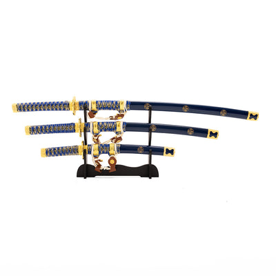 Showcase the SMAI Samurai 3pc Sword & Stand - Blue, featuring three Japanese swords with blue and gold handles and sheaths, elegantly arranged from largest to smallest on a sleek black stand.