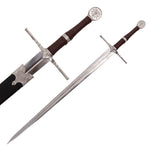 The SMAI Medieval Sword - Witch Hunter Deluxe features a silver crossguard and pommel with a sun-like symbol, brown wrapped handle, and long double-edged blade. Shown both sheathed and unsheathed—ideal for cosplay.