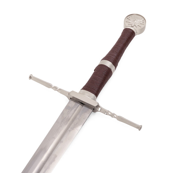 The SMAI Medieval Broadsword - Witch Hunter features a stainless steel blade, brown leather-wrapped hilt, ornate silver crossguard, and a round wolf-engraved pommel, displayed on a white background.