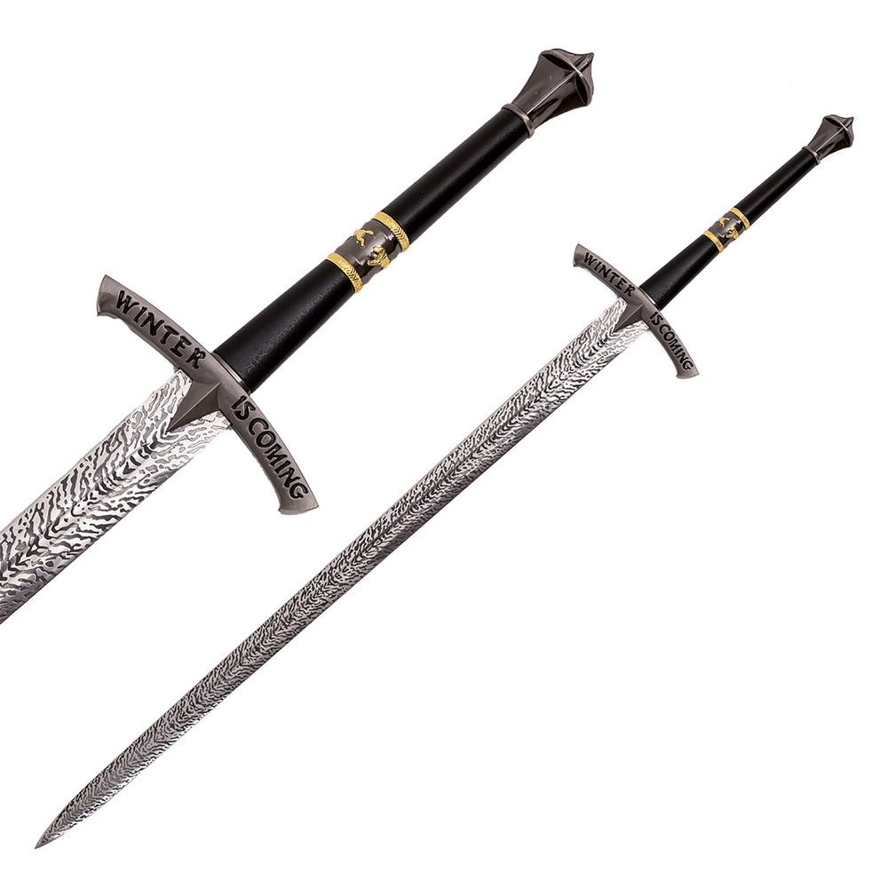 The SMAI Medieval Display Broadsword - Blizzard features a patterned silver blade, black and gold hilt, and a guard engraved with "WINTER IS COMING." Shown from two angles on a white background.