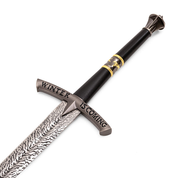 The SMAI Medieval Display Broadsword - Blizzard features a patterned blade, engraved "Winter Is Coming" crossguard, and a black hilt with gold accents, making it an eye-catching fantasy greatsword for any collection.