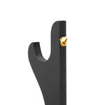 A close-up of the SMAI Double Sword Display Stand with a black curved design and a gold-colored metal hanger near the top, shown against a plain white background.