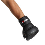 A person wearing Elite85 MMA Gloves - Black by SMAI, crafted from durable cowhide leather, holds their fist forward against a white background.