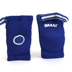 These blue Muay Thai elbow pads by SMAI, perfect for grappling in combat sports, come with white straps and feature "SMAI" printed on one pad. They also have an open circular design on one side to ensure mobility and comfort.