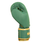 The SMAI Gold Series Boxing Glove in Green/Gold stands upright on a plain white background, highlighting its exceptional wrist support for enhanced stability during demanding training sessions.