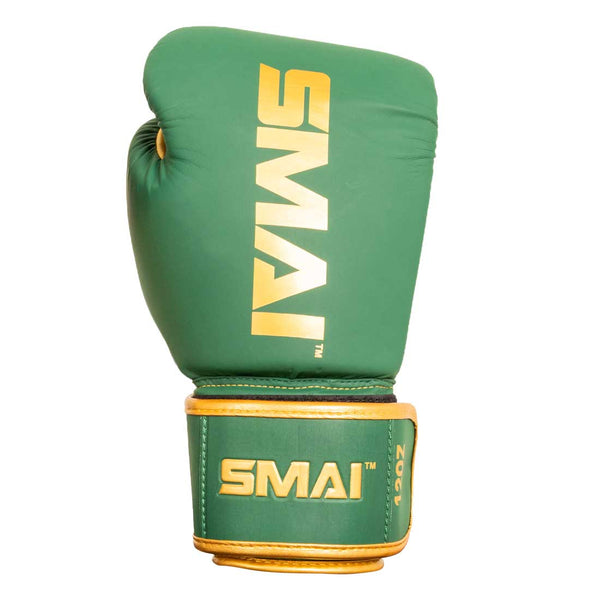 The SMAI Gold Series Boxing Glove in Green/Gold features gold trim and the SMAI brand name printed in gold on both the glove and wrist strap, offering superior wrist support and shock protection for training.