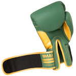 The Gold Series Boxing Glove - Green/Gold by SMAI features a green and gold design with a black and gold wrist strap, displaying the palm side and the "SMAI" branding on the wrist area. It is designed to provide excellent wrist support for enhanced comfort during training.