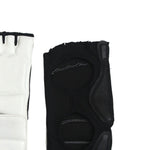 Two Taekwondo Foot Protectors from SMAI are displayed against a white background. The protector on the left, primarily white with black accents, contrasts with the right protector's black textured design featuring EVA foam padding and cutouts that reveal interior stitching—perfect for an ergonomic fit.