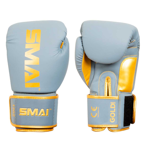 A pair of light blue and gold Gold Series Boxing Gloves by SMAI, displayed from the front and back, featuring Velcro wrist straps for enhanced wrist support and stitched detailing.