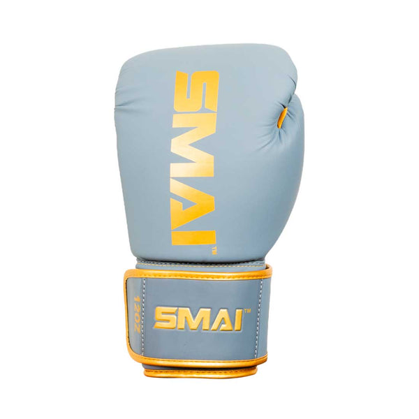 A light blue boxing glove with gold "SMAI" branding on the front and wrist strap, offering superior shock protection and wrist support, shown against a white background.