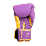 The SMAI Gold Series Boxing Glove - Purple/Gold showcases "GOLD SERIES" and certification symbols on the wrist strap, offering enhanced wrist support for superior shock protection, and is photographed against a white background.