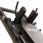 Close-up of a SMAI Leg Press / Hack Squat Combo - Light Commercial, featuring padded shoulder rests and textured grip handles.