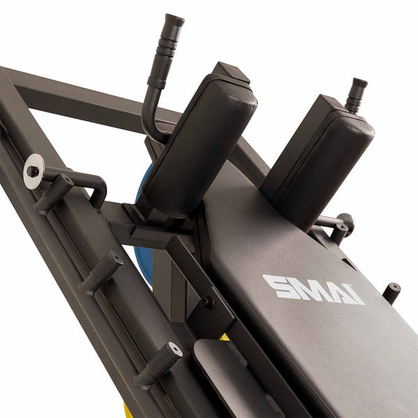 Close-up of a SMAI Leg Press / Hack Squat Combo - Light Commercial, featuring padded shoulder rests and textured grip handles.