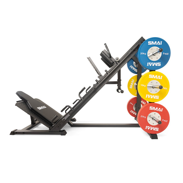 A SMAI Leg Press / Hack Squat Combo - Light Commercial in a home gym, loaded with blue, yellow, and red weight plates on a vertical storage rack.