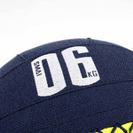 Close-up of an SMAI Wall Balls - Hybrid Range in dark blue with white "SMAI 06 KG" text. Features visible stitched seams, durable aramid fibre construction, and a small yellow detail at the base.