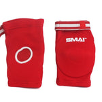 The Muay Thai Elbow Pads by SMAI are shown in red, ideal for combat sports. One pad features the brand’s logo and a circular opening at the back. They include white and red striped elastic bands for easy adjustment, and their versatility makes them perfect for providing support during intense grappling sessions too.