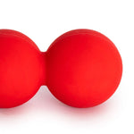 A vibrant red Peanut Roller by SMAI, made from sturdy rubber, with two connected spheres spanning 15cm, offers muscle therapy and myofascial massage for spine alignment and relaxation against a plain white background.