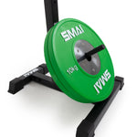A green 10kg weight plate with the brand "SMAI" is mounted on a black squat stand from Sale Item's Portable Squat Stand - Red / Black (Pair). The round plate features a silver metal center and is positioned vertically. The sturdy stand boasts a rectangular base, providing stability during use.