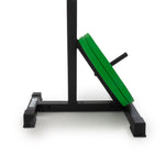 Close-up of a black weightlifting sled with green weight plates stacked on one side, somewhat similar to the Portable Squat Stand - Red / Black (Pair). The sled features a sturdy base and a vertical support bracket for carrying the weights, with the brand "Sale Item" visible on the frame.