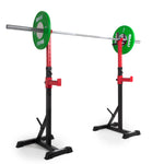 A weightlifting barbell with green weights is placed on the Portable Squat Stand in red and black, crafted by Sale Item. The squat stand includes adjustable height settings and sturdy black bases for stability during workouts. The weights carry the "SMAI" label, all set against a plain white background.