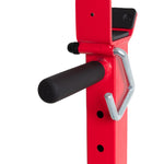 Close-up of the Sale Item Portable Squat Stand in red and black, showcasing an adjustable metal bracket with a black padded handle and a sturdy steel locking pin. The design includes multiple adjustment holes, ideal for securely supporting equipment effectively.