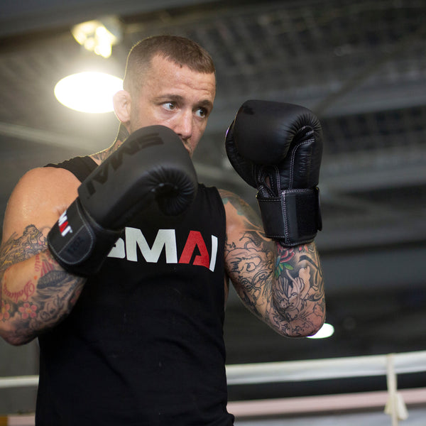 Man using SMAI Black Elite85 Boxing Gloves (pair)