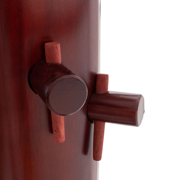 Close-up of the SMAI Kung Fu Dummy - Freestanding, crafted from polished rosewood. This martial arts equipment features cylindrical protrusions on the side for Wing Chun training, highlighting its rich grain patterns.