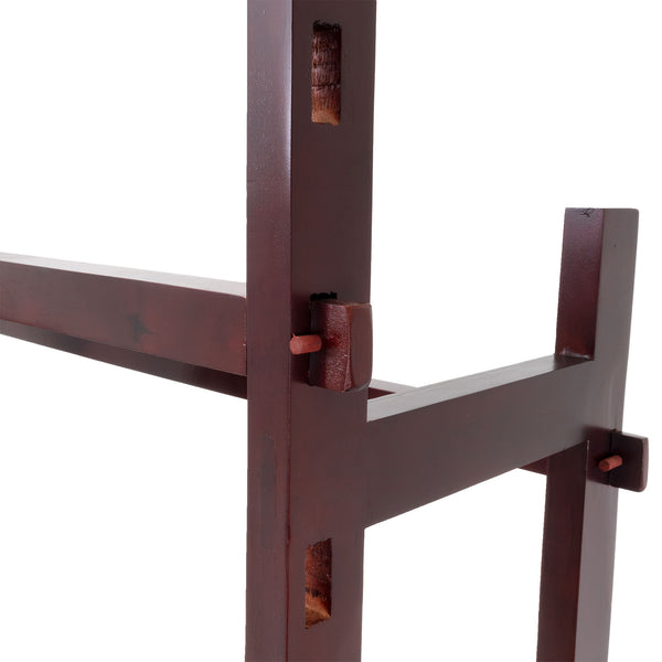 Close-up of the Kung Fu Dummy - Freestanding by SMAI, crafted from dark brown rosewood with interlocking joints. Visible wooden pegs highlight its exceptional craftsmanship, blending minimalist aesthetics with structural integrity reminiscent of a Wing Chun training apparatus.