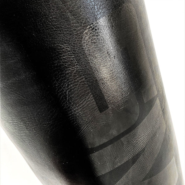 Punching Bag - 5ft Triple Black Close up of  leather texture