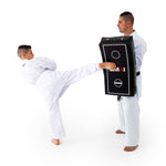 Man holding Shield - Shoc Tec Curved while boy kicks it