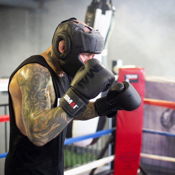 Man using the SMAI Black Elite85 Boxing Gloves (pair)