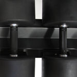 A close-up view showcases two black, rubber-coated dumbbells from the SMAI Commercial Dumbbell Set with Rack (5-60kg) resting neatly on their rack. The metal handles feature a textured grip, and the weights are perfectly aligned to emphasize their smooth, matte finish—ideal gym equipment for any setting.