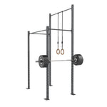 SMAI Rig - 2 Squat Cell with Bridge featuring a barbell loaded with weight plates and wooden gymnastic rings hanging from the high gauge steel crossbeam.