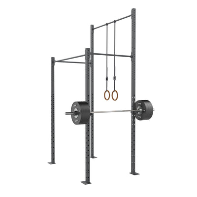SMAI Rig - 2 Squat Cell with Bridge featuring a barbell loaded with weight plates and wooden gymnastic rings hanging from the high gauge steel crossbeam.