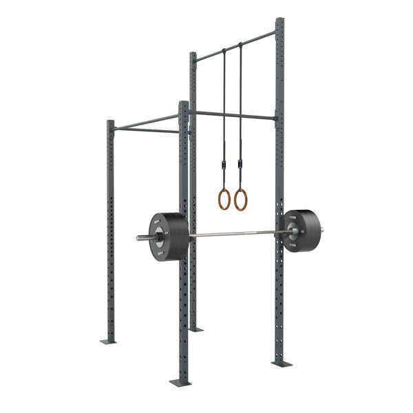 SMAI Rig - 2 Squat Cell with Bridge featuring a barbell loaded with weight plates and wooden gymnastic rings hanging from the high gauge steel crossbeam.